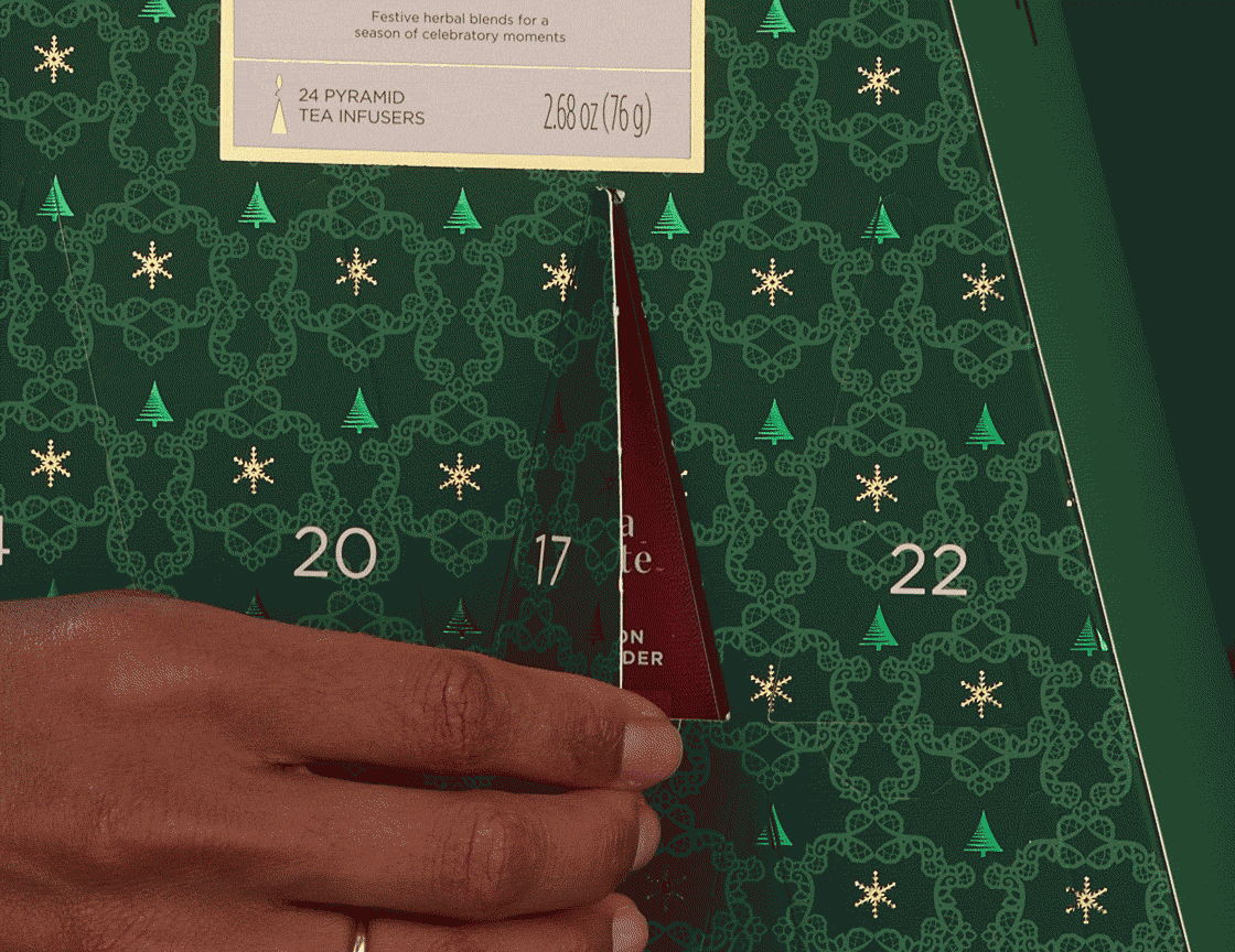 Warming Joy Advent Calendar Herbal, animation showing hand opening one of the doors to reveal a pyramid infuser
