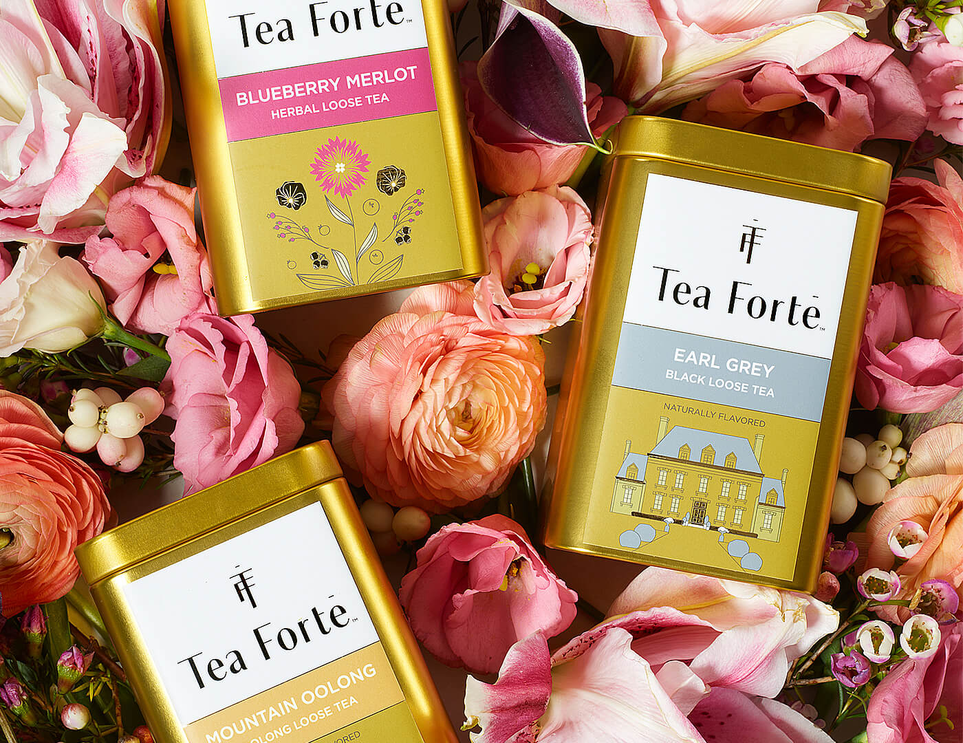 Loose leaf tea canisters on a bed of flower petals