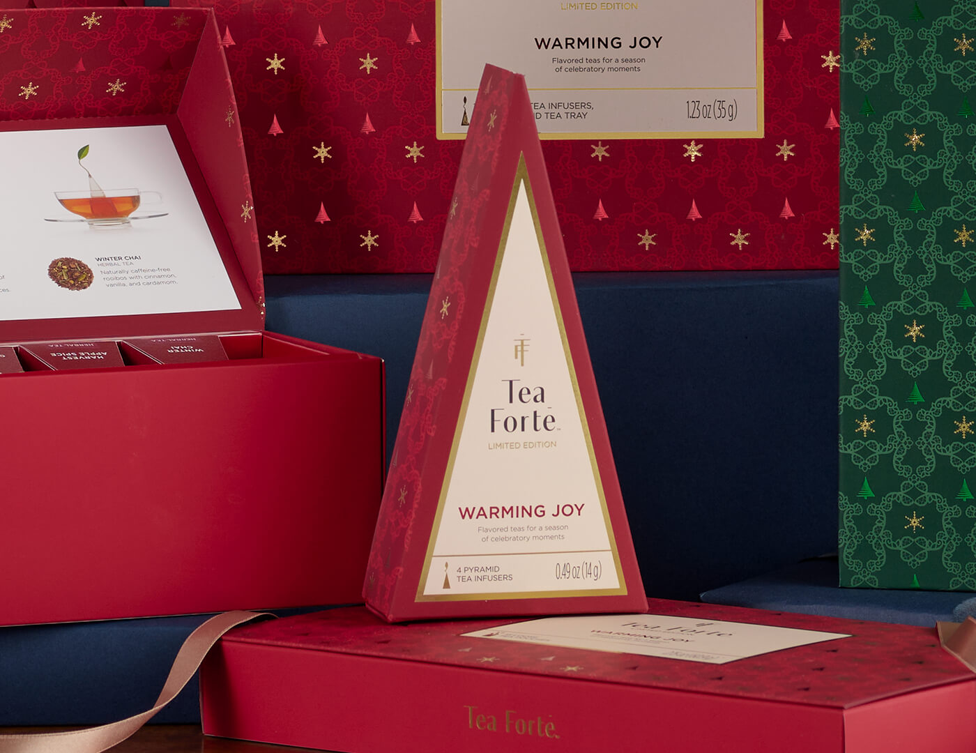 Petite Tea Tree Warming Joy, closed with other red boxes around it